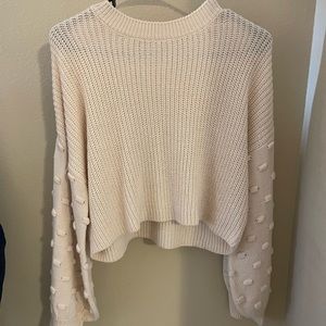 Buckle mock neck sweater with sleeve details. Size S. Cream.